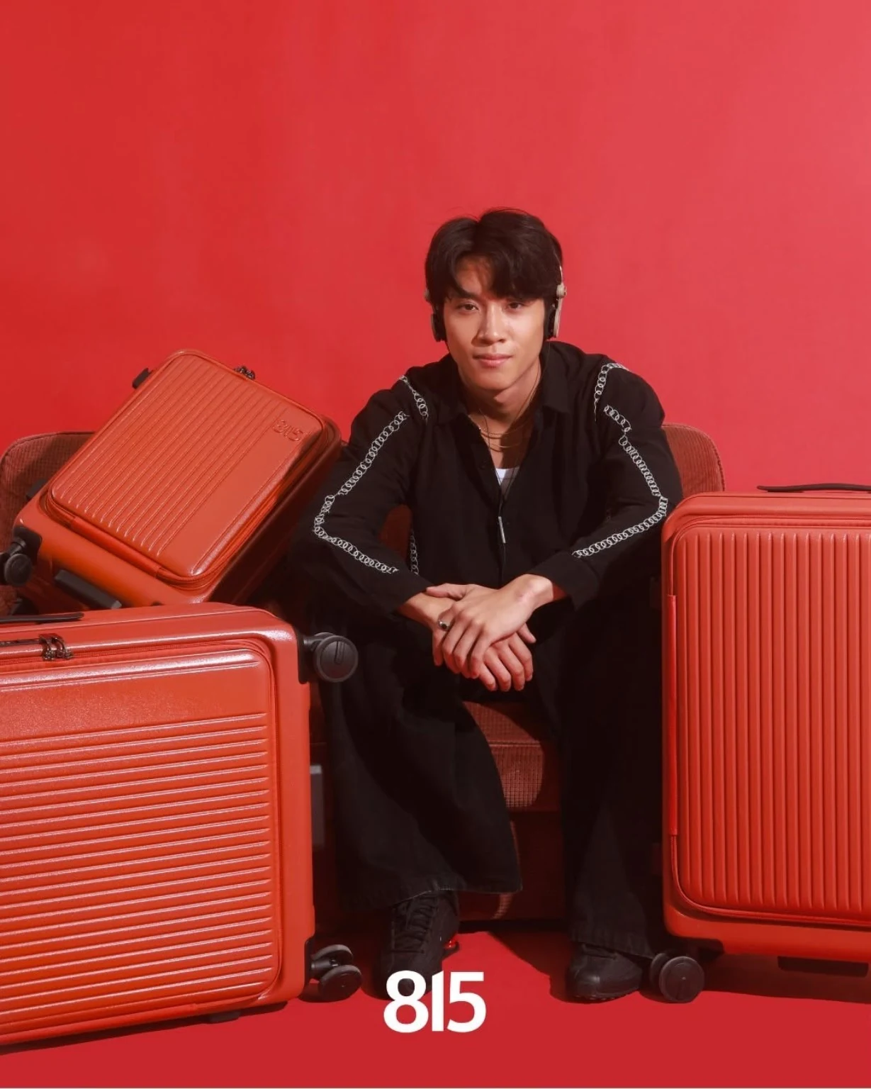 Neron Zach seated with red 815 luggage